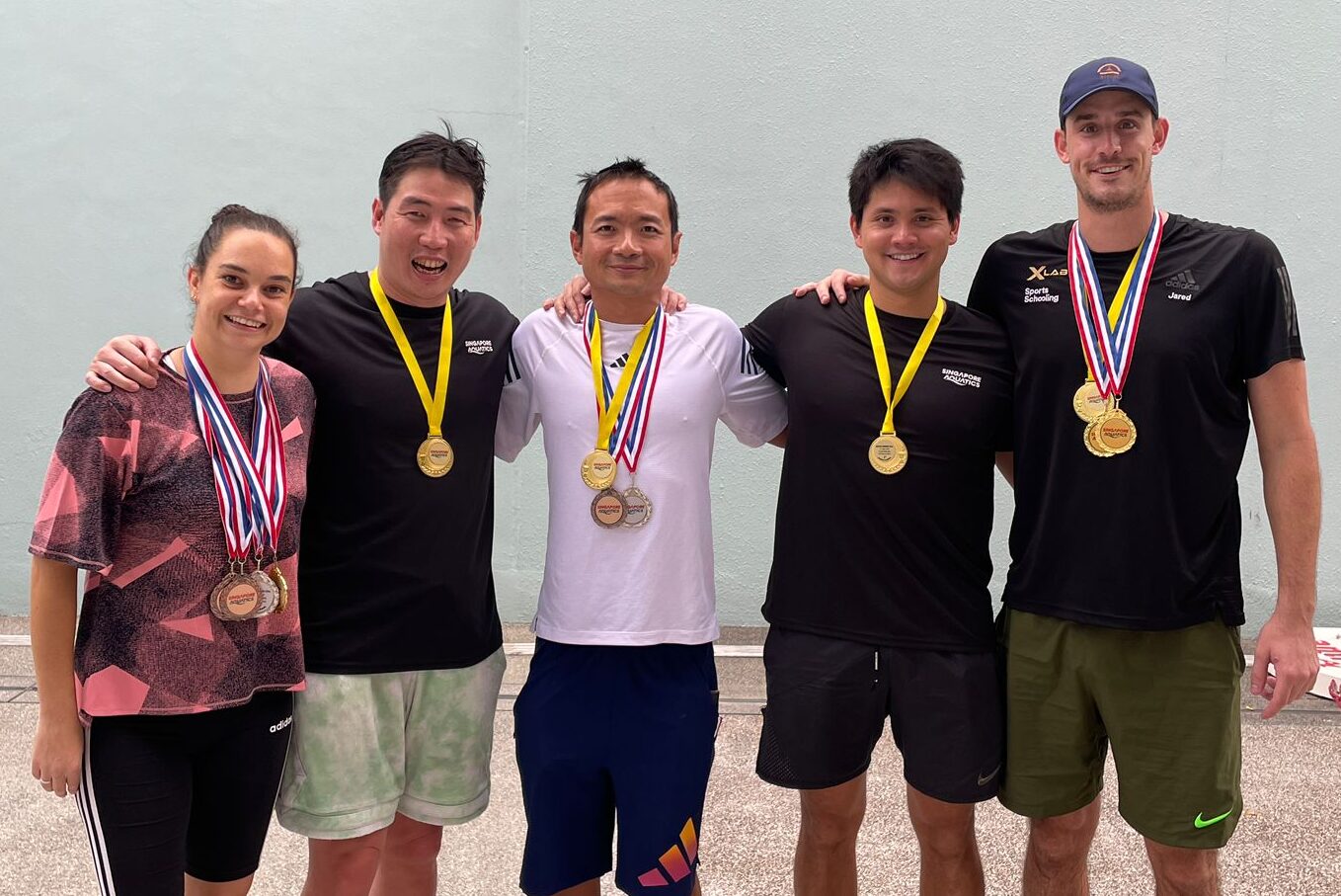 X Lab adult masters swimmers with gold medals at Masters competition